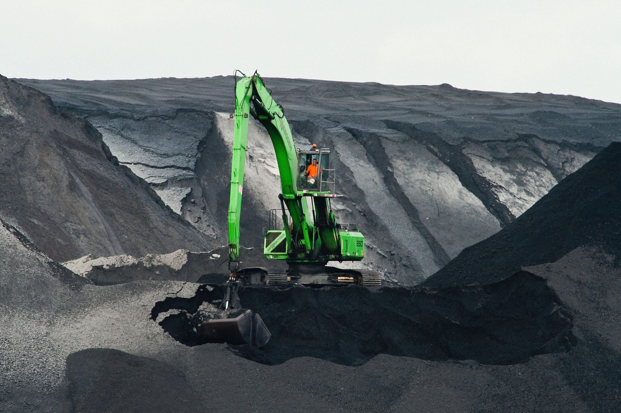 Contractor on green escavator.